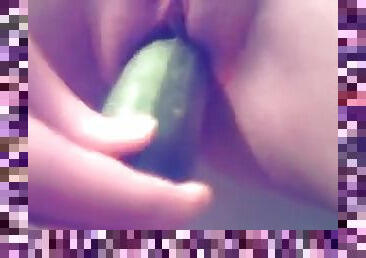 Close up on girl fucking zucchini into her pussy