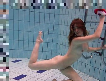 Raunchy brunette hussy enjoys swimming in the pool in the nude