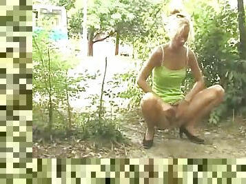 Horny slut outdoor in high heels pissing on the ground