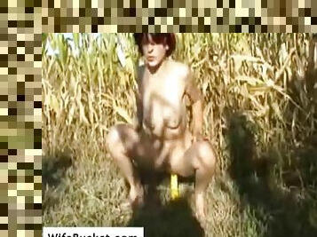 Wife slut fucking her pussy in a field of corn