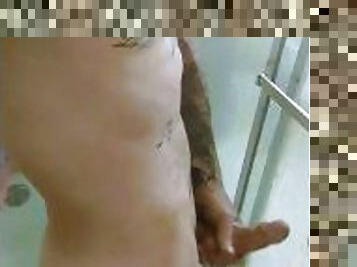 Sexy man with tattoos jacking his cock in the shower