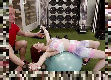 Sexy redhead Lilian Stone works out and gets fucked in the gym
