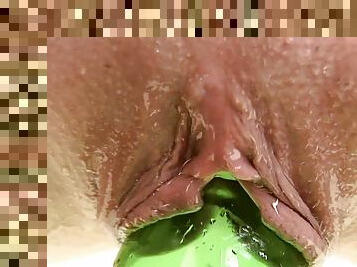 Alisa fucks her pussy with a bottle in the bathroom