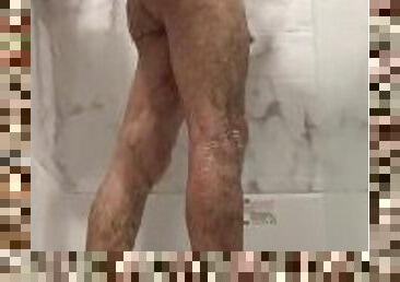 Hot guy cleans himself in the shower.