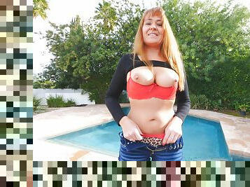 Mature redhead Elexis exposes her huge tits while wearing jeans