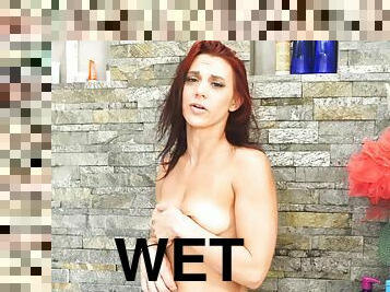 Insolent redhead toys her peach under the shower during a wet romance