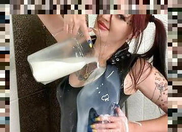 Latex fetish. Rubber. Latex dress is doused with milk