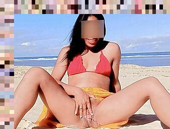 She pisses on a public beach in front of the camera.compilation