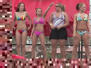 Some hot chicks in bikinis shake their butts in public