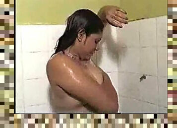Indian milf shows her boobs while having shower.